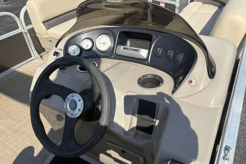 Slide: The Image of 2021 Sun Tracker Party Barge® 18 DLX dashboard with steering wheel and controls. - 17