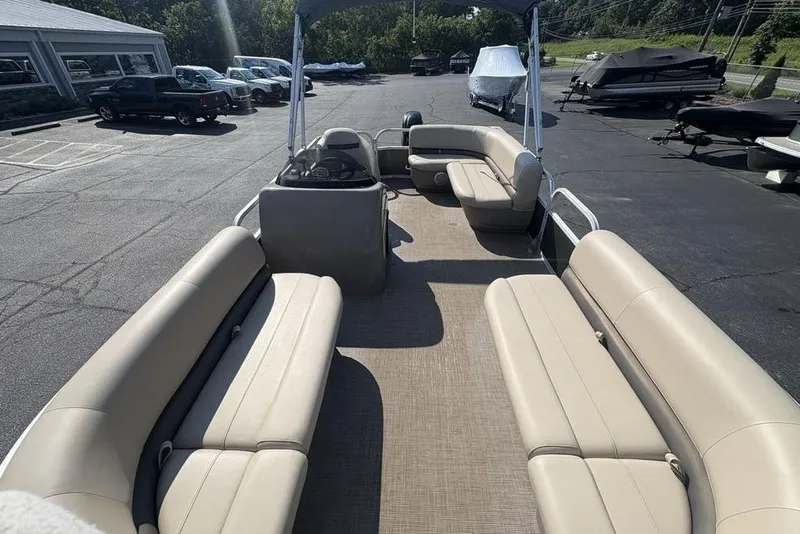 Slide: The Image of 2021 Sun Tracker Party Barge® 18 DLX pontoon boat with beige seating, parked outdoors. - 23