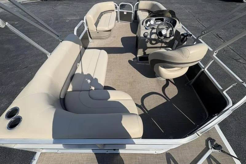 Slide: The Image of 2021 Sun Tracker Party Barge® 18 DLX interior with beige seating and steering console. - 24