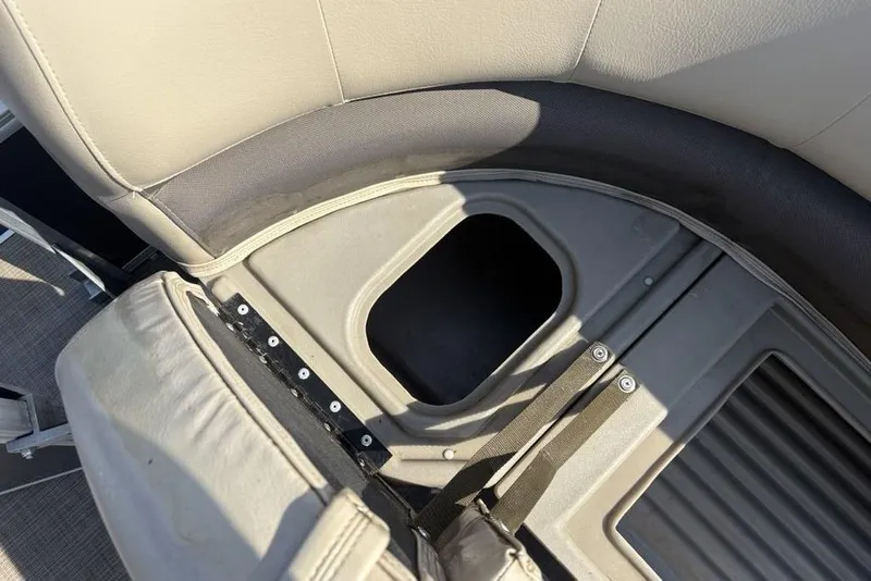 Slide: The Image of Sun Tracker Party Barge® 18 DLX 2021 seat storage compartment, beige upholstery, open hatch. - 6