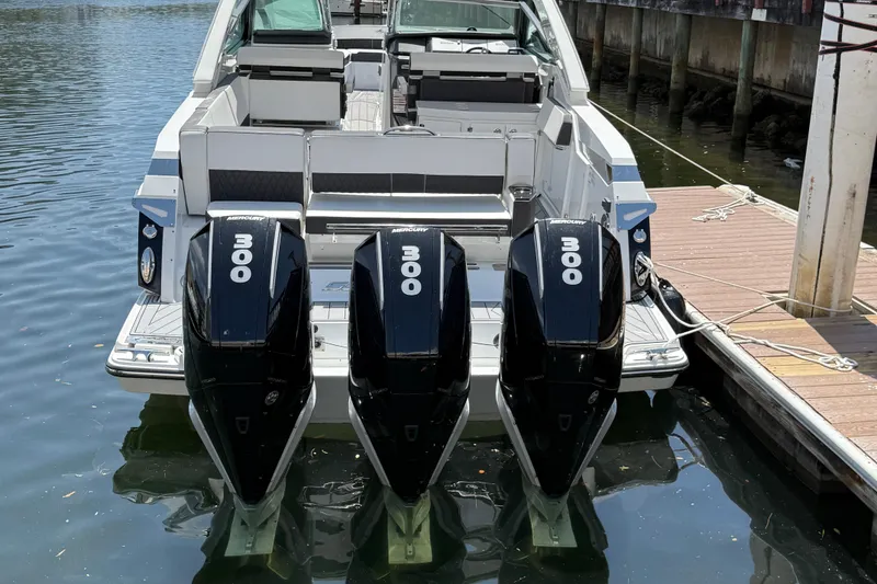 Slide: The Image of 2023 Monterey 385 Super Sport boat with triple 300 horsepower Mercury engines docked. - 12