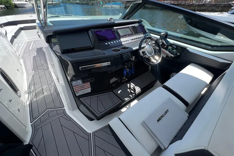 Slide: The Image of 2023 Monterey 385 Super Sport boat cockpit with modern controls and sleek design. - 15