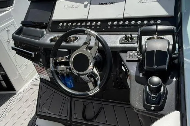 Slide: The Image of 2023 Monterey 385 Super Sport boat dashboard with steering wheel and controls. - 16