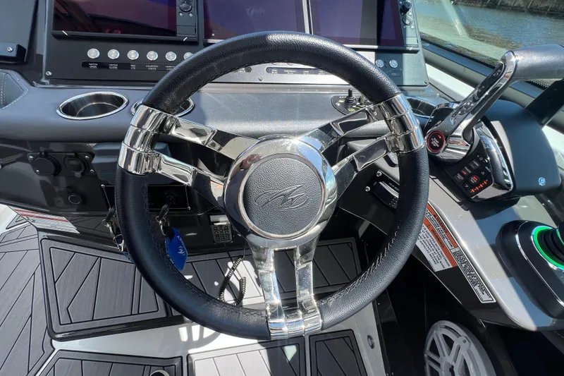 Slide: The Image of Steering wheel and controls of 2023 Monterey 385 Super Sport boat cockpit. - 17