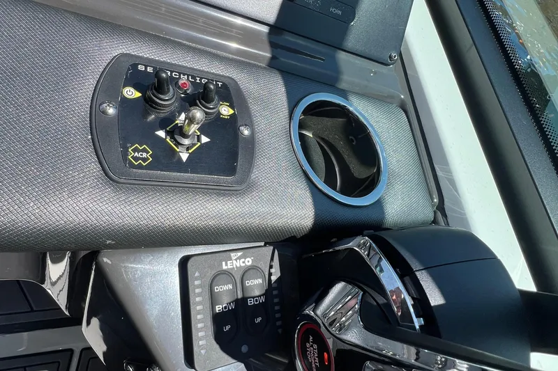 Slide: The Image of Control panel of 2023 Monterey 385 Super Sport boat with joystick and cup holder. - 18