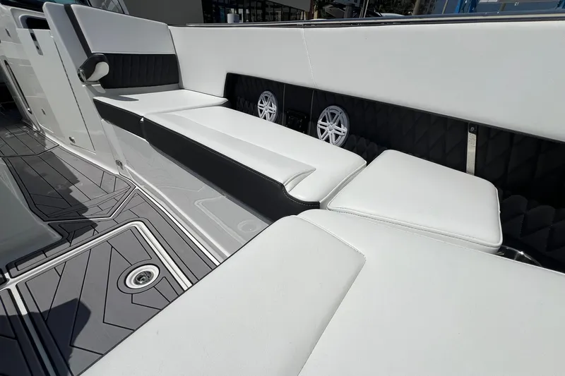 Slide: The Image of 2023 Monterey 385 Super Sport boat interior with white seating and modern design. - 24