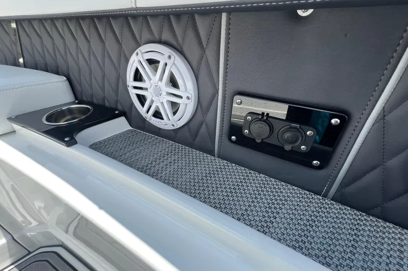 Slide: The Image of 2023 Monterey 385 Super Sport interior with speaker, cup holder, and power outlets. - 25