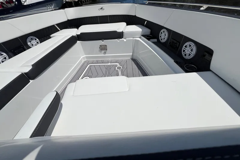 Slide: The Image of 2023 Monterey 385 Super Sport boat interior with sleek seating and modern speakers. - 26