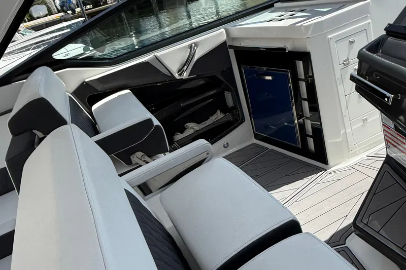 Slide: The Image of Interior of 2023 Monterey 385 Super Sport boat with modern seating and storage. - 31