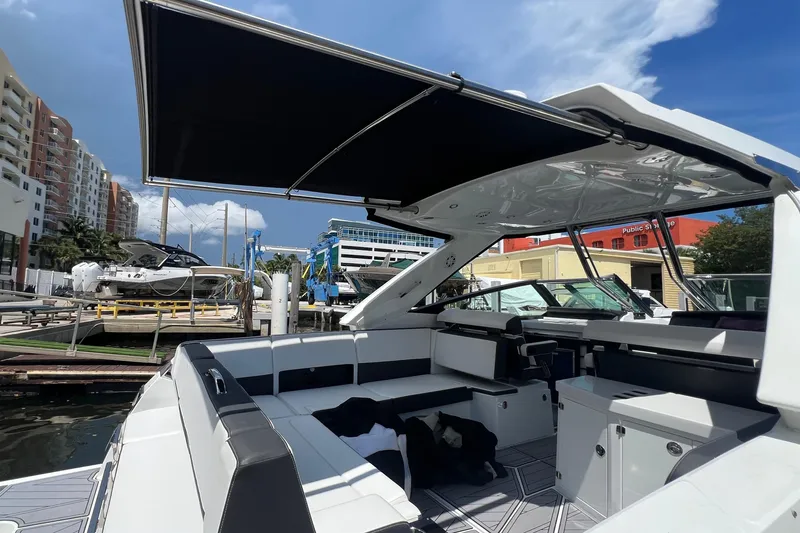 Slide: The Image of 2023 Monterey 385 Super Sport boat docked, featuring spacious seating and modern design. - 37