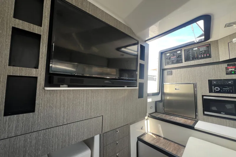 Slide: The Image of 2023 Monterey 385 Super Sport interior with modern entertainment system and sleek cabinetry. - 43
