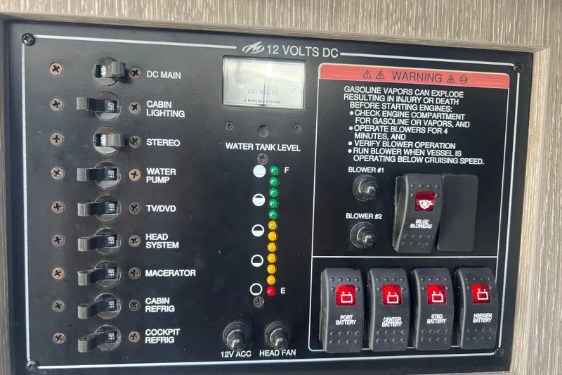 Slide: The Image of Control panel of 2023 Monterey 385 Super Sport boat with switches and warning labels. - 45