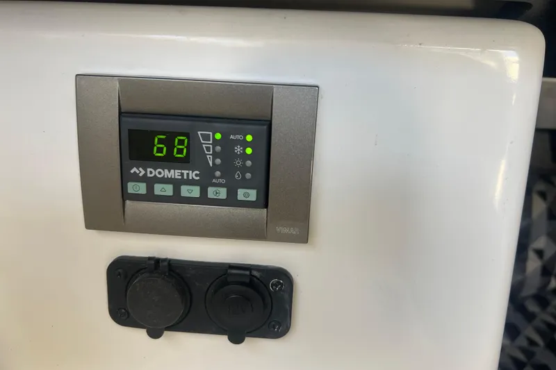 Slide: The Image of Dometic control panel in 2023 Monterey 385 Super Sport boat interior. - 48