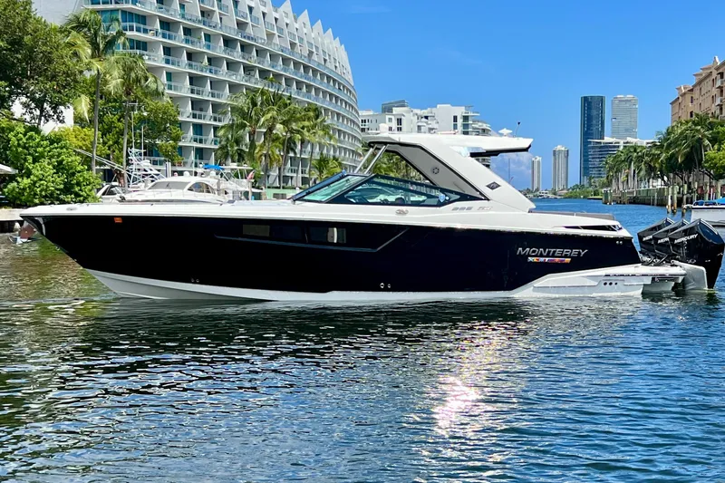 Slide: The Image of 2023 Monterey 385 Super Sport boat on a scenic waterfront with modern buildings. - 5