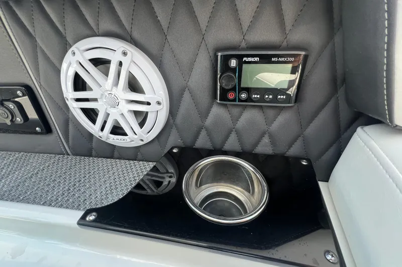 Slide: The Image of 2023 Monterey 385 Super Sport interior with speaker, control panel, and cup holder. - 51