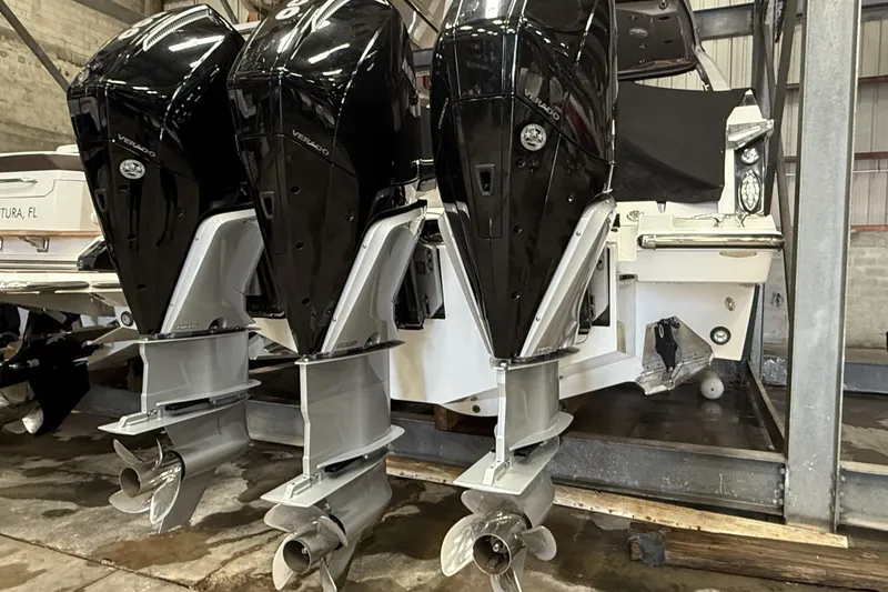 Slide: The Image of 2023 Monterey 385 Super Sport with triple outboard engines in a storage facility. - 54