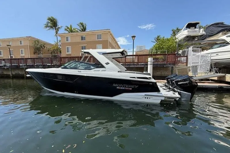 Slide: The Image of 2023 Monterey 385 Super Sport boat docked in sunny marina setting. - 6