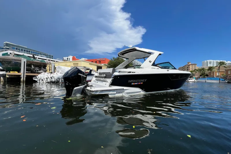 Slide: The Image of 2023 Monterey 385 Super Sport boat docked in a marina under a clear blue sky. - 62
