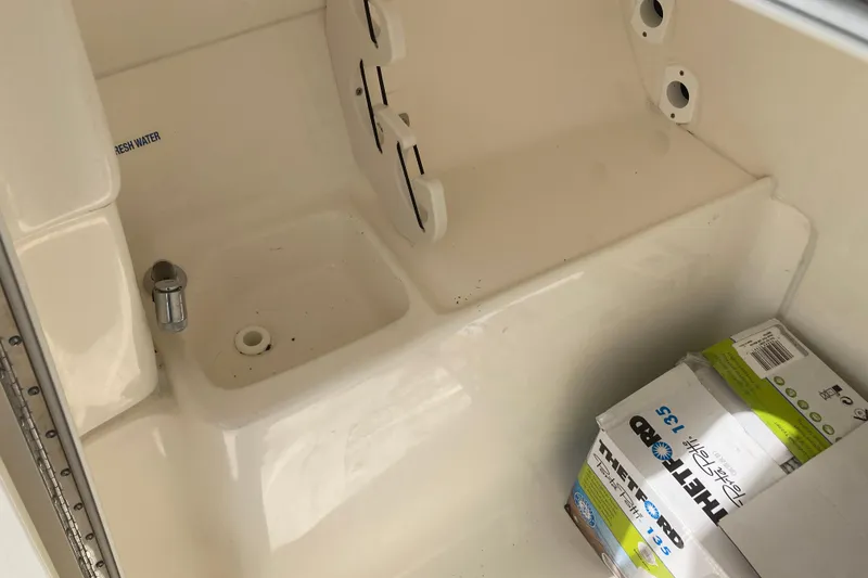 Slide: The Image of Interior of 2022 Key West 239 DFS boat with fresh water compartment and storage box. - 10