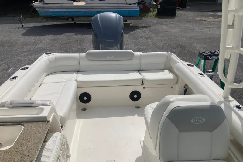 Slide: The Image of 2022 Key West 239 DFS boat interior with white seating and motor view. - 12