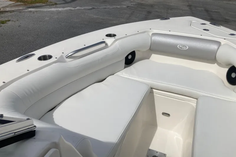 Slide: The Image of 2022 Key West 239 DFS boat interior with white cushioned seating and cup holders. - 13