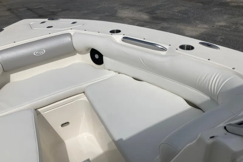 Slide: The Image of 2022 Key West 239 DFS boat interior with white cushioned seating and cup holders. - 14