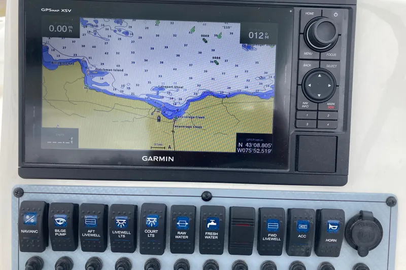Slide: The Image of Garmin GPS display on 2022 Key West 239 DFS boat dashboard with control switches. - 16
