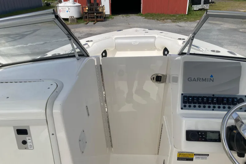 Slide: The Image of 2022 Key West 239 DFS boat interior with Garmin navigation system and open deck view. - 17