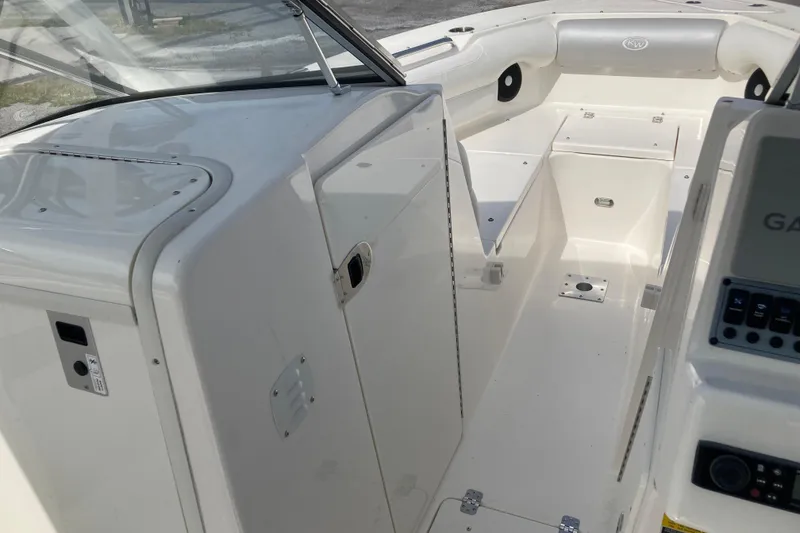 Slide: The Image of 2022 Key West 239 DFS boat interior with seating and control panel. - 18
