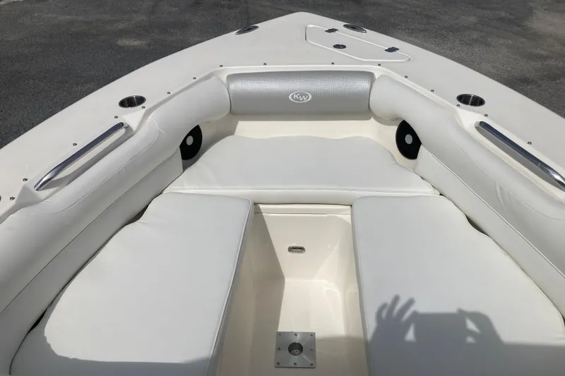 Slide: The Image of 2022 Key West 239 DFS boat interior with white cushioned seating and cup holders. - 21
