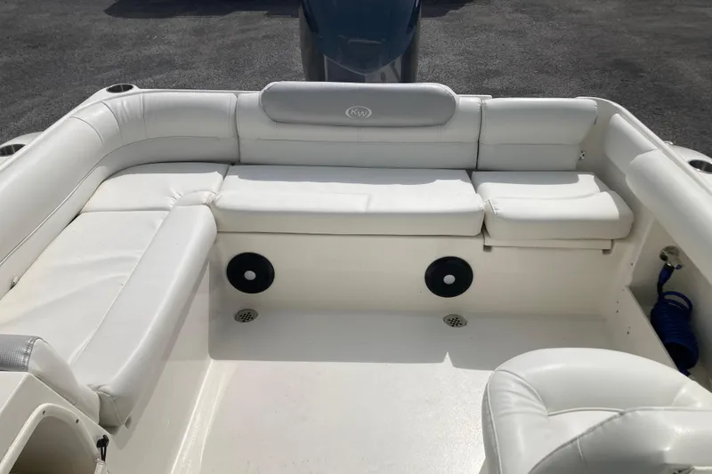 Slide: The Image of 2022 Key West 239 DFS boat interior with white seating and cup holders. - 22