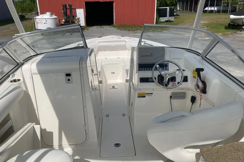 Slide: The Image of 2022 Key West 239 DFS boat interior with steering wheel and Garmin navigation system. - 6