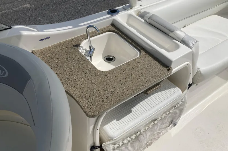Slide: The Image of 2022 Key West 239 DFS boat interior with sink and seating area. - 7
