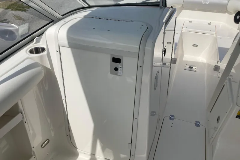Slide: The Image of 2022 Key West 239 DFS boat interior with storage compartment and cup holder. - 8