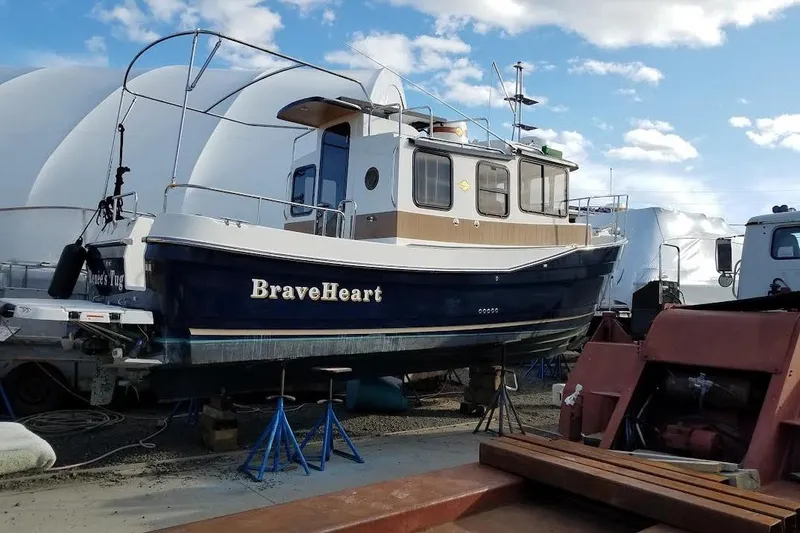 The Image of 2016 Ranger Tugs R25 SC boat named BraveHeart on dry dock under blue sky. - 0