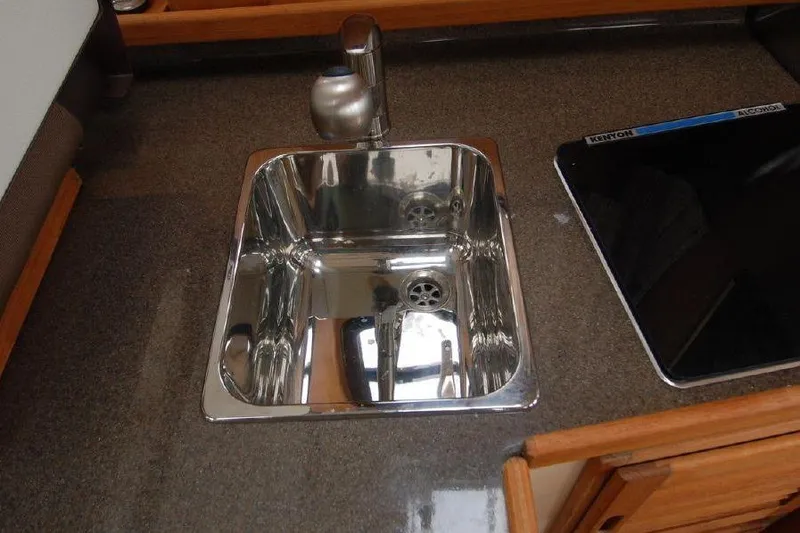 Slide: The Image of Stainless steel sink and cooktop in 2016 Ranger Tugs R25 SC boat kitchen. - 10