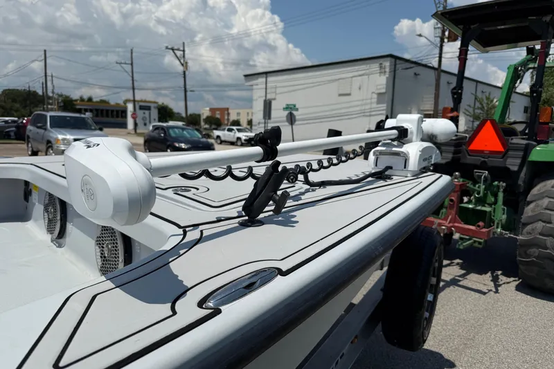 Slide: The Image of 2017 Majek M2 ILLUSION boat with trolling motor, parked near a tractor on a sunny day. - 16