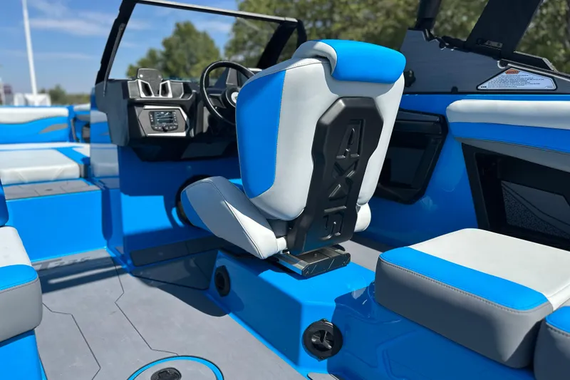 Slide: The Image of 2026 Axis T235 boat interior with blue and white seating, modern dashboard, and steering wheel. - 12