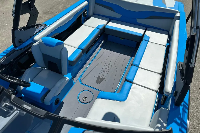 Slide: The Image of 2026 Axis T235 boat interior with blue and gray seating, showcasing modern design. - 18