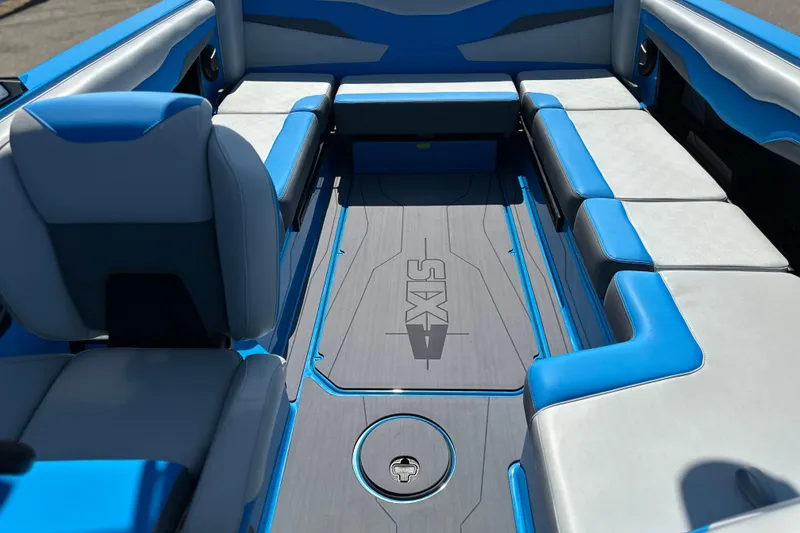 Slide: The Image of 2026 Axis T235 boat interior with blue and gray seating, showcasing modern design. - 7