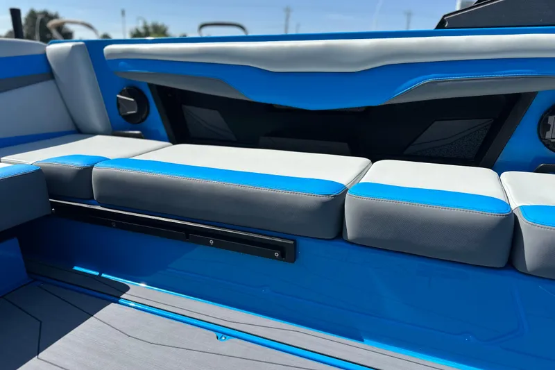 Slide: The Image of 2026 Axis T235 boat interior with blue and gray seating, showcasing modern design. - 9