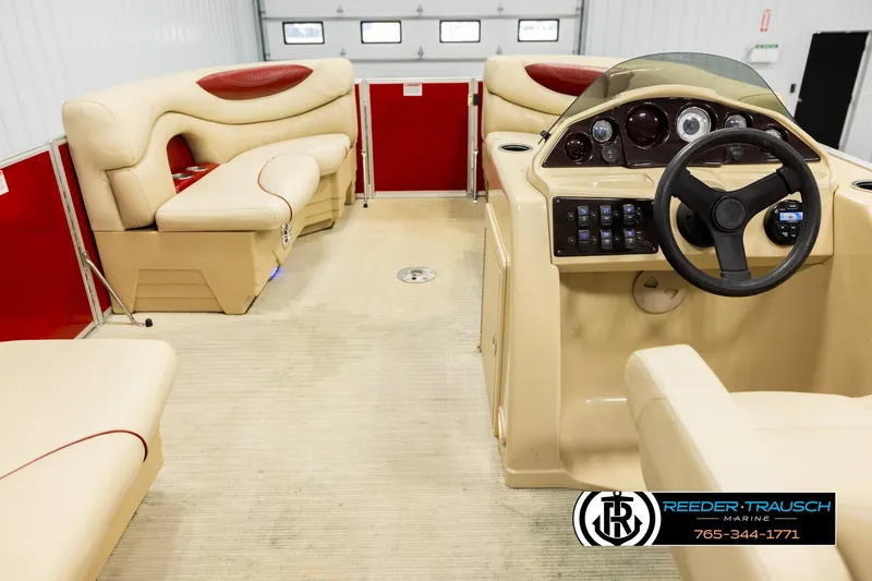 Slide: The Image of 2017 Sylvan 818 Mirage CR boat interior with beige seating and steering console. - 17