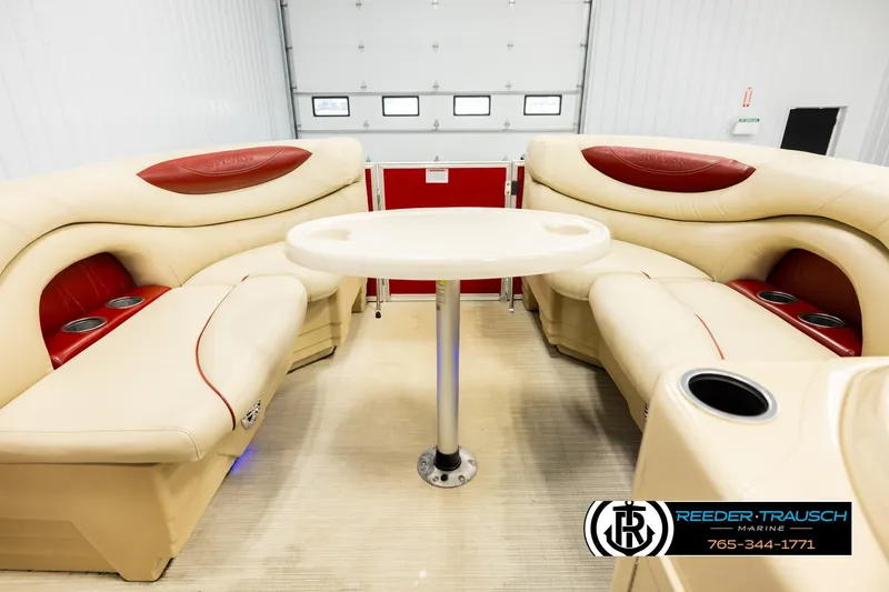 Slide: The Image of 2017 Sylvan 818 Mirage CR interior with beige seating and central table in a showroom. - 19