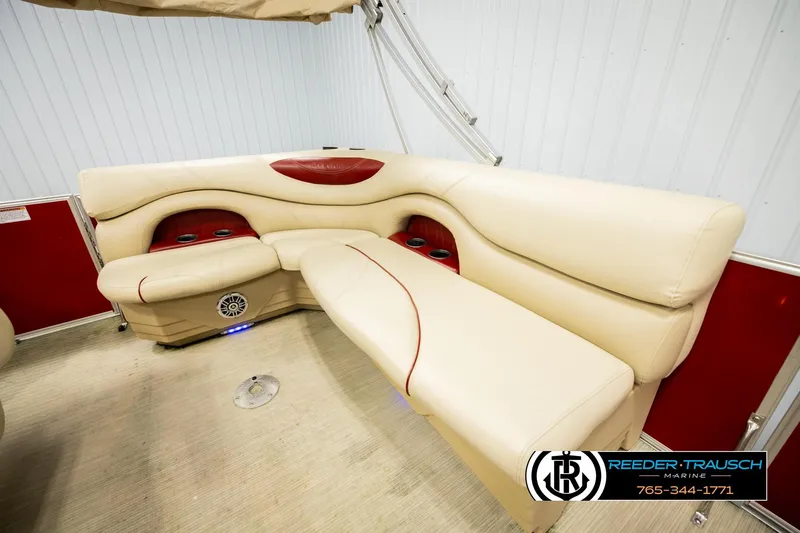 Slide: The Image of 2017 Sylvan 818 Mirage CR boat interior with beige seating and red accents. - 21