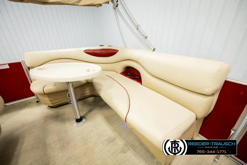 Slide: The Image of 2017 Sylvan 818 Mirage CR boat interior with beige seating and round table. - 22