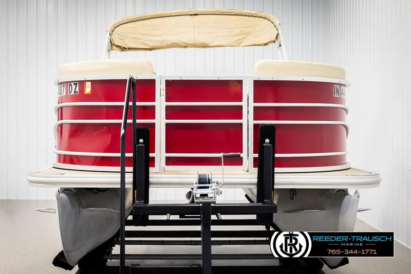 Slide: The Image of 2017 Sylvan 818 Mirage CR pontoon boat with red exterior on display indoors. - 8