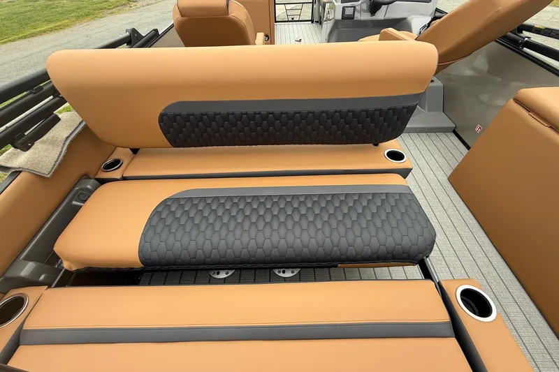 Slide: The Image of 2026 Sylvan L-3 DLZ DH boat interior with tan and black seating, cup holders, and modern design. - 7