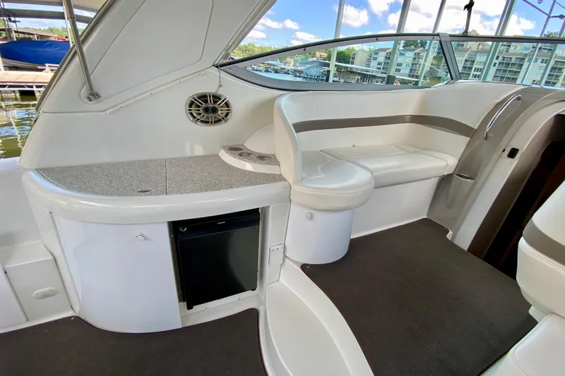 Slide: The Image of 2004 Formula 37 PC yacht interior with seating, mini fridge, and countertop. - 13