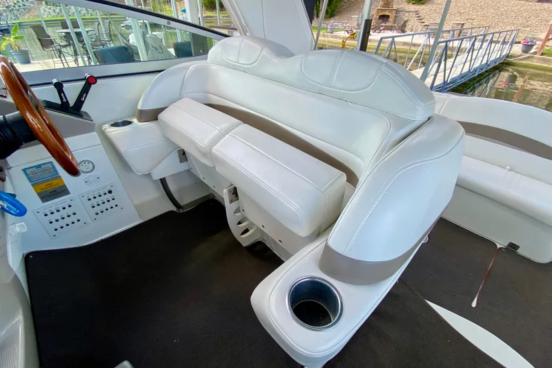 Slide: The Image of 2004 Formula 37 PC boat interior with white leather seating and wooden steering wheel. - 16