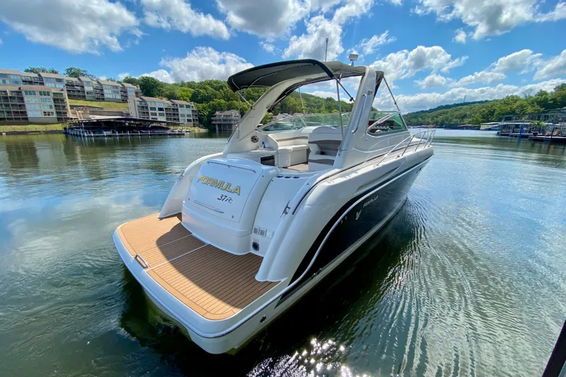 Slide: The Image of 2004 Formula 37 PC yacht on serene lake with scenic backdrop. - 2